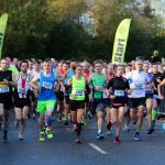 Group of runners passing the start line
